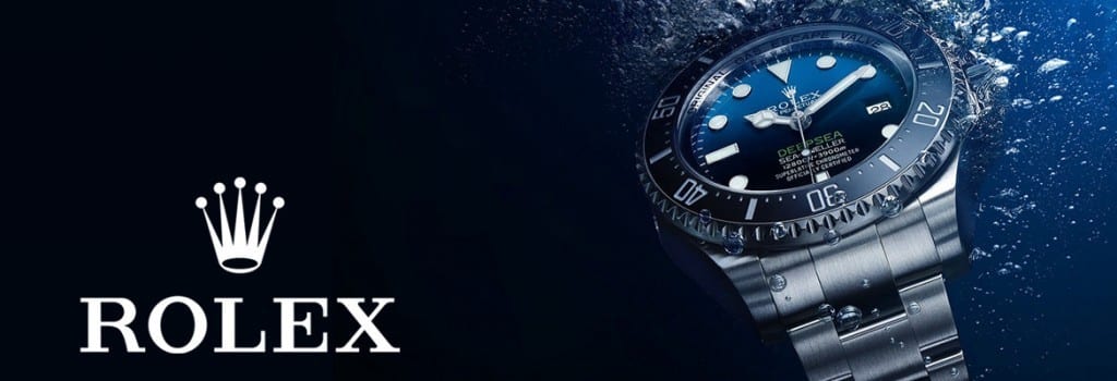 Rolex watch with water droplets on a dark background
